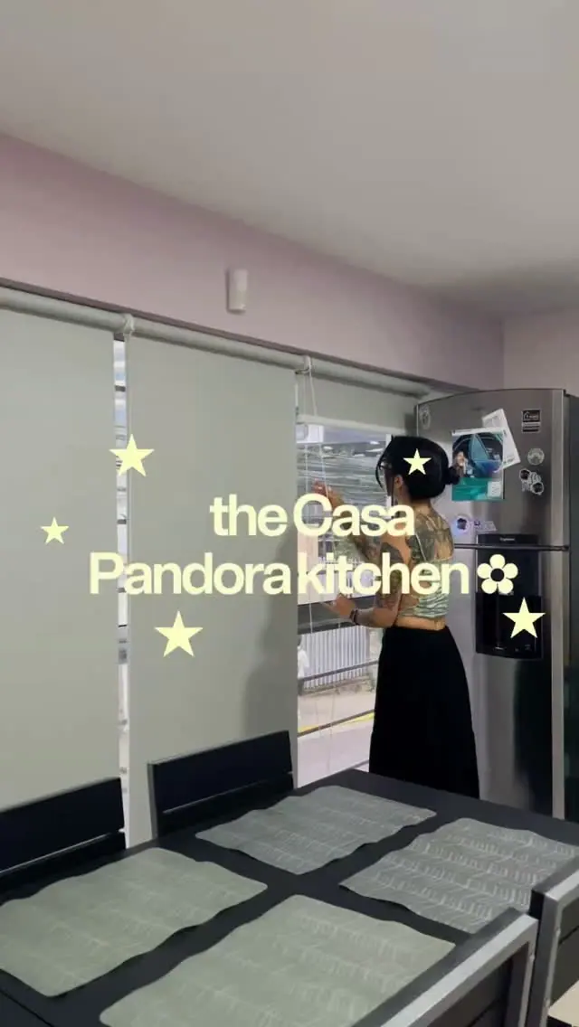 Cover of the Instagram reel “The Casa Pandora kitchen”: a guest at the fridge beside the dining table
